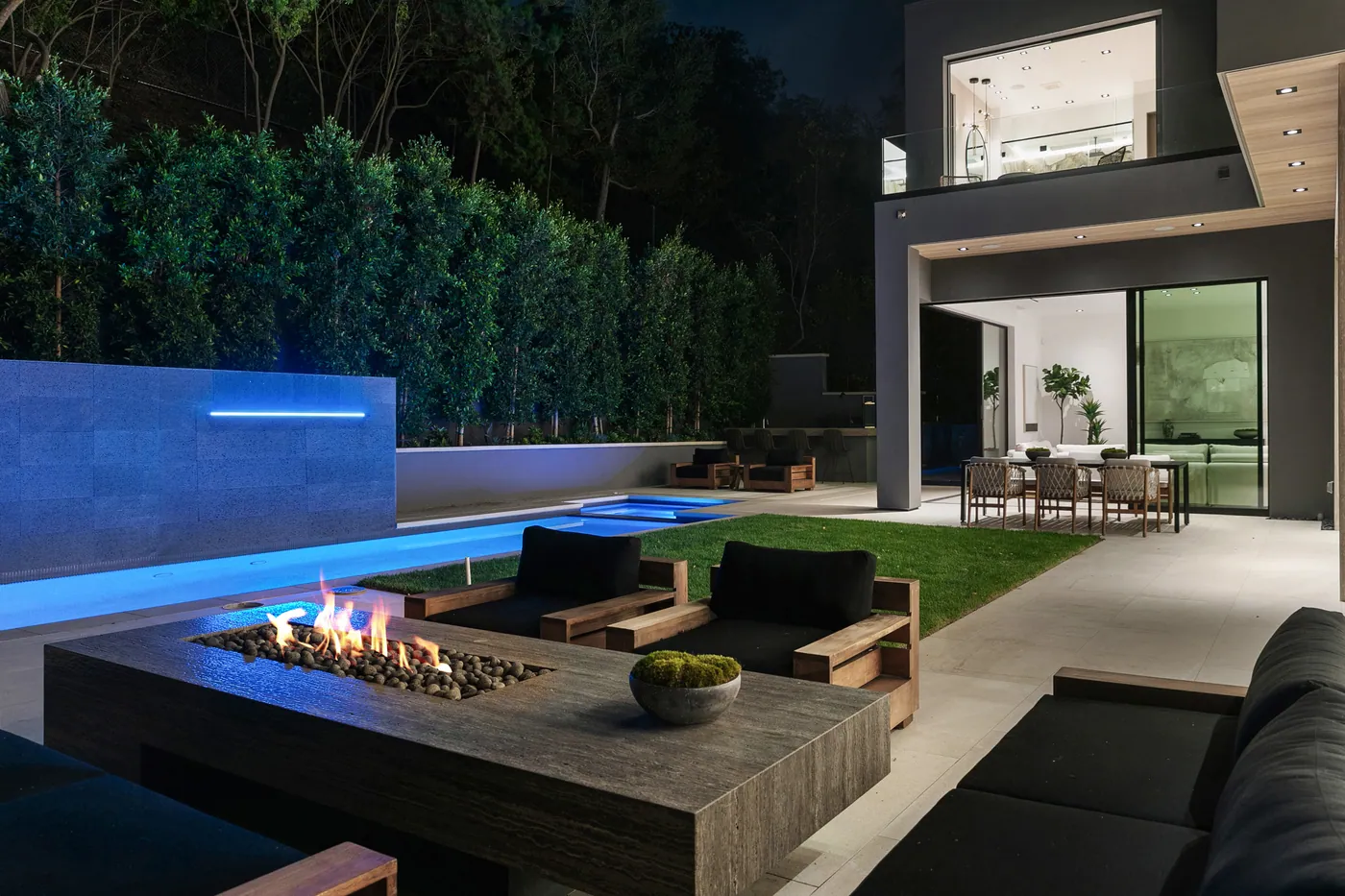 Outdoor lounge and water wall at night