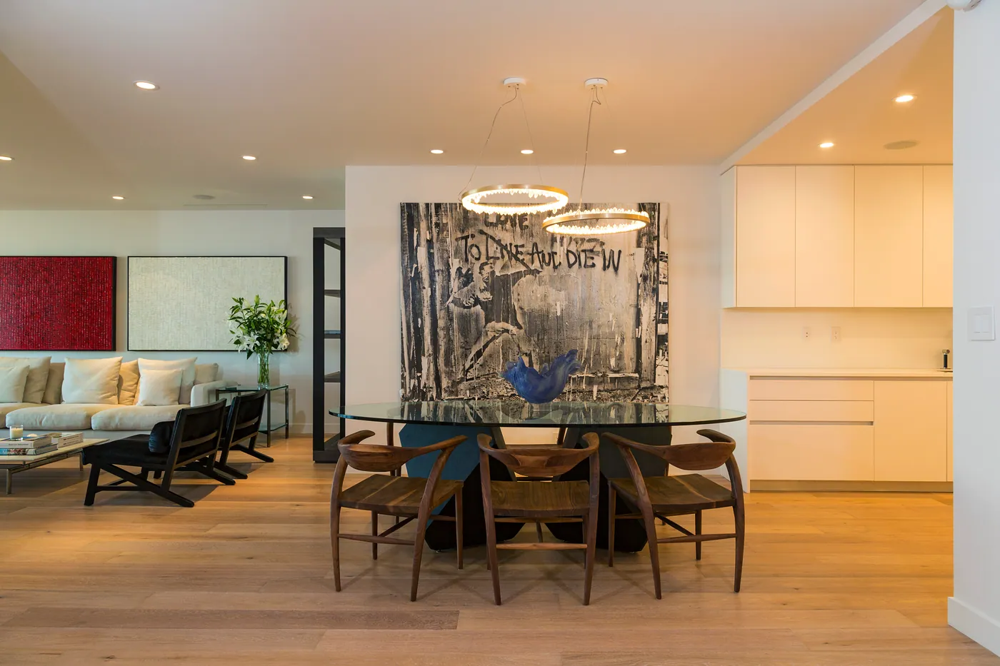 Dining room with a ring chandelier and large artwork