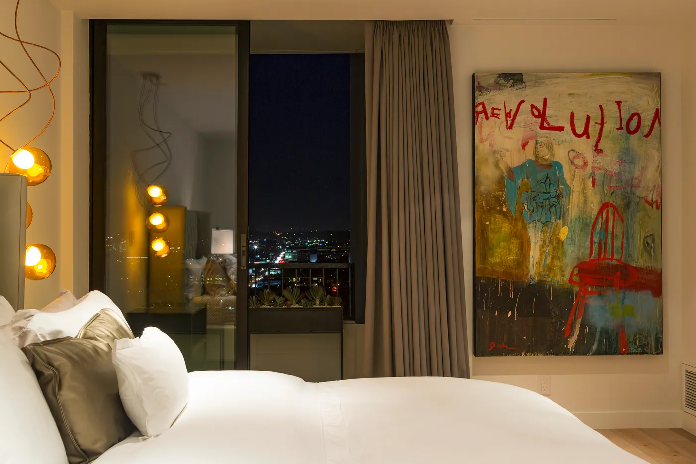 Bedroom with pendant lights and artwork