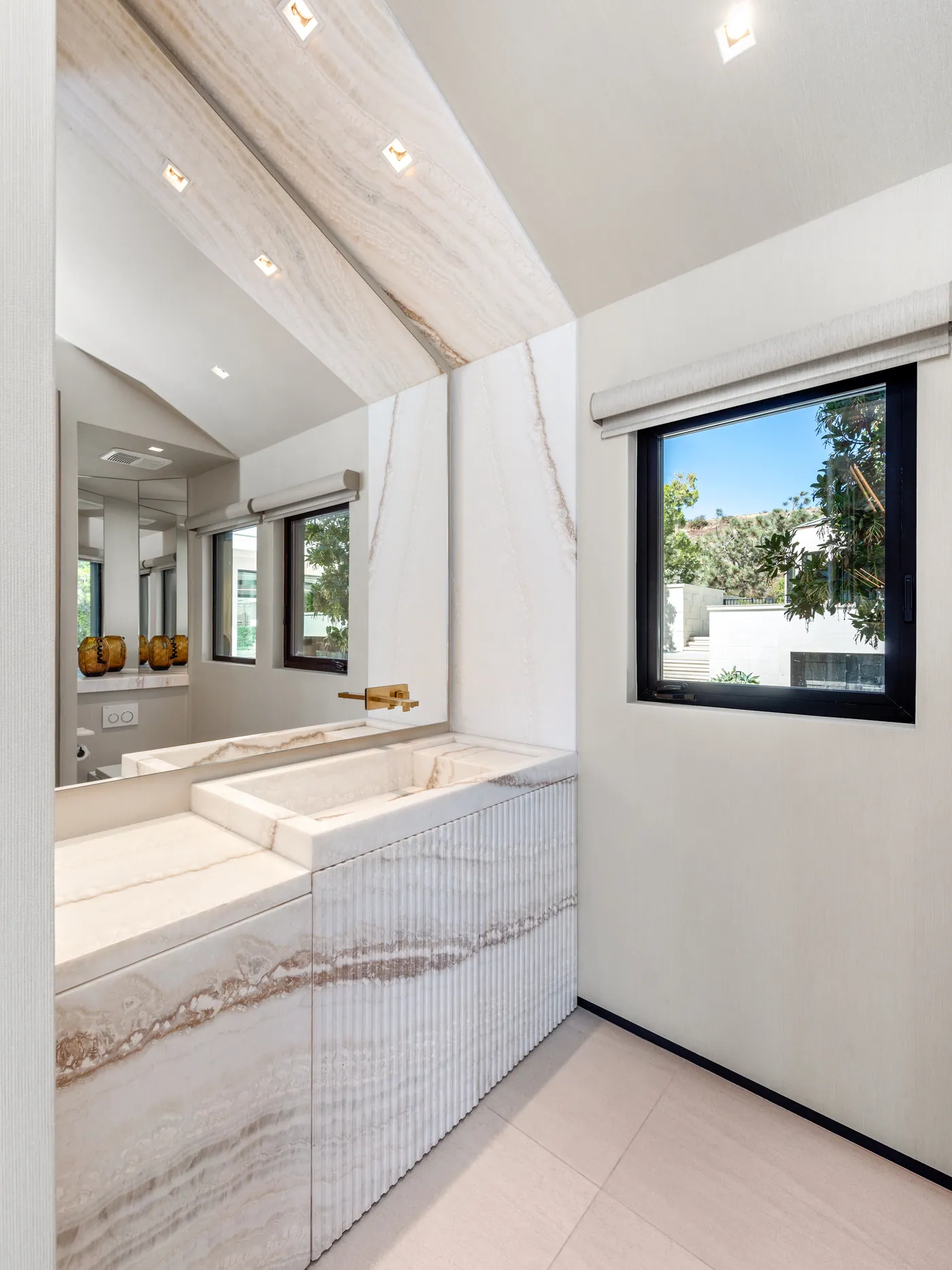 Bath vanity in book-matched stone
