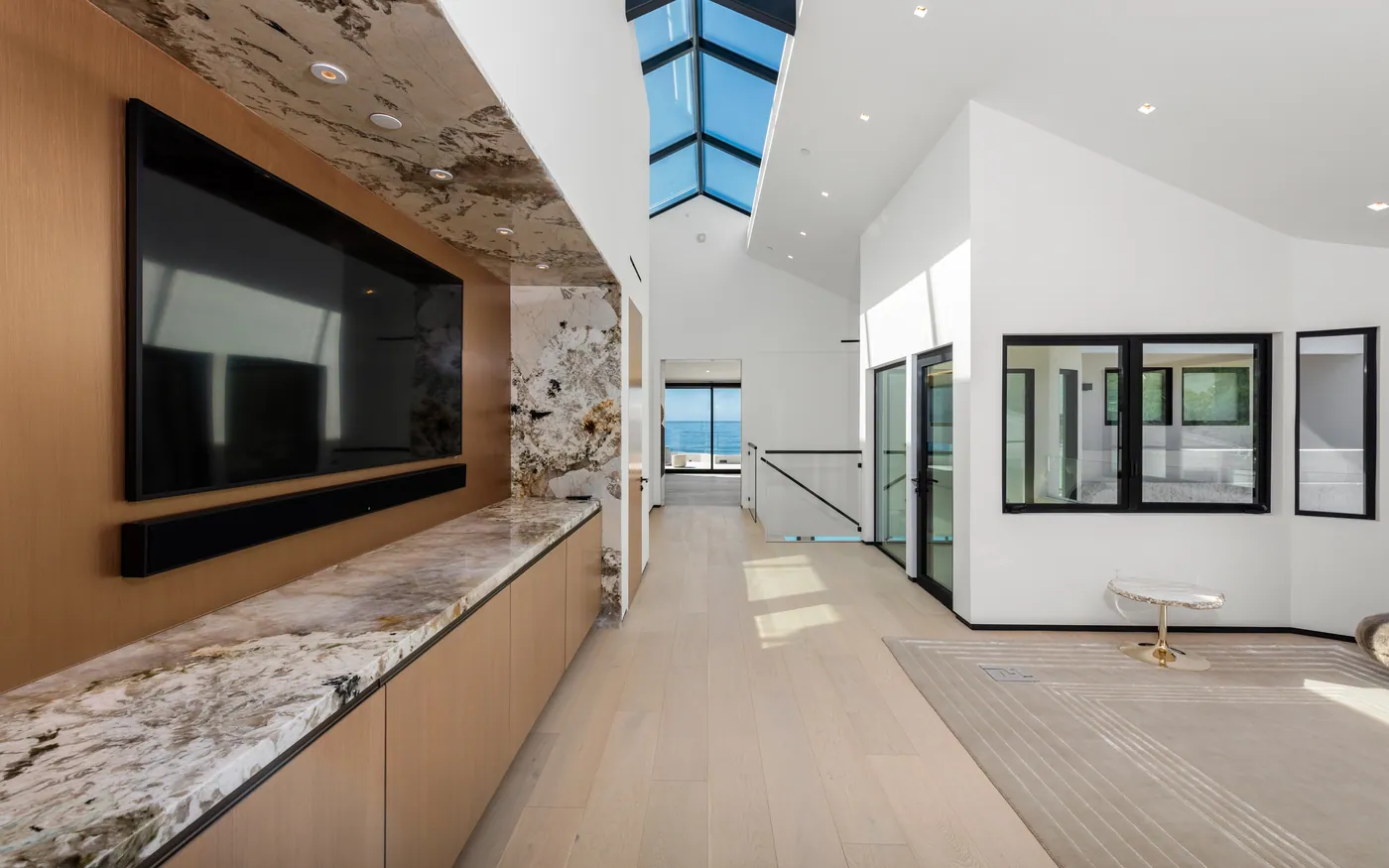 Upper hall with stone wall and skylight