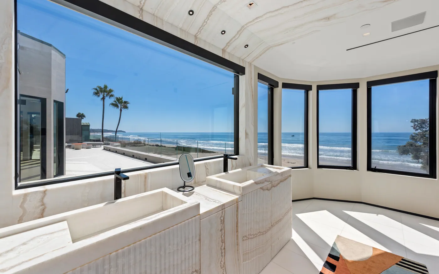Twin vanities under a wall of windows