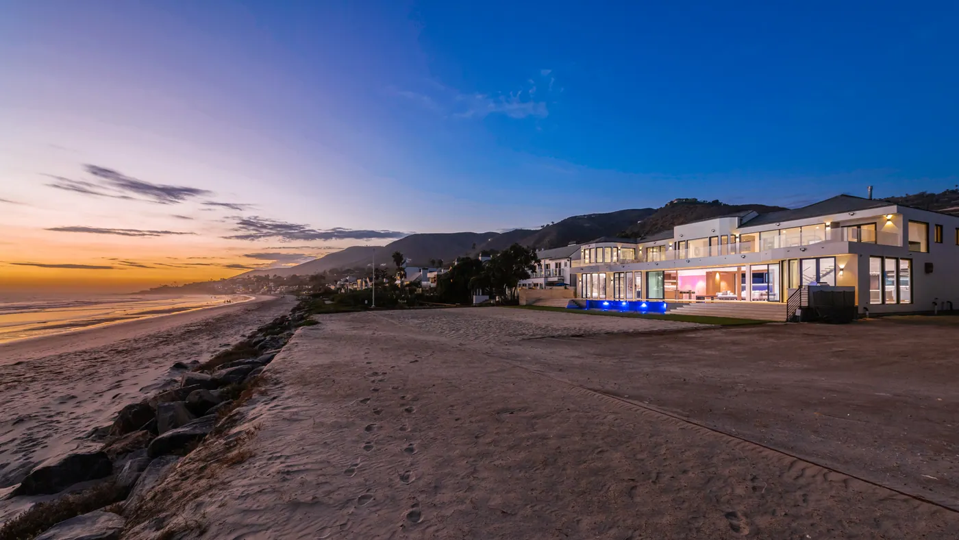 The house from the beach at sunset