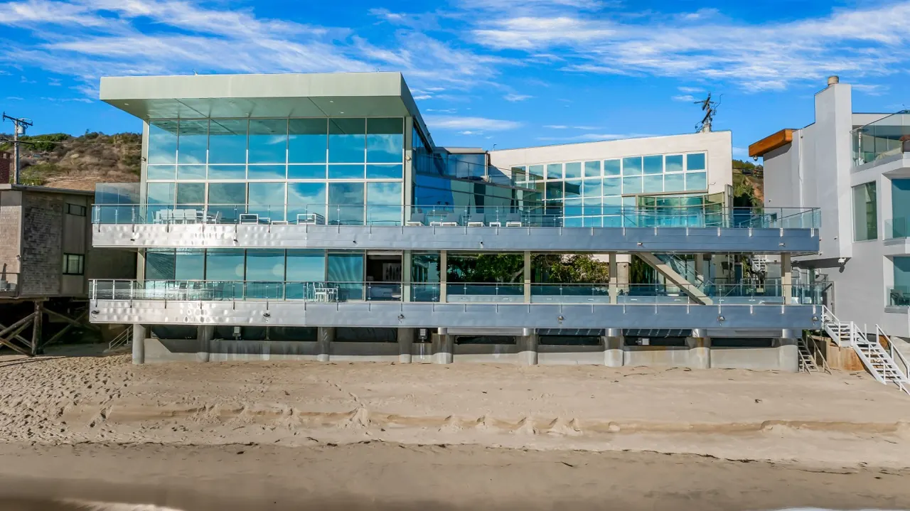 The beach elevation in daylight, the glass volumes set above the sand