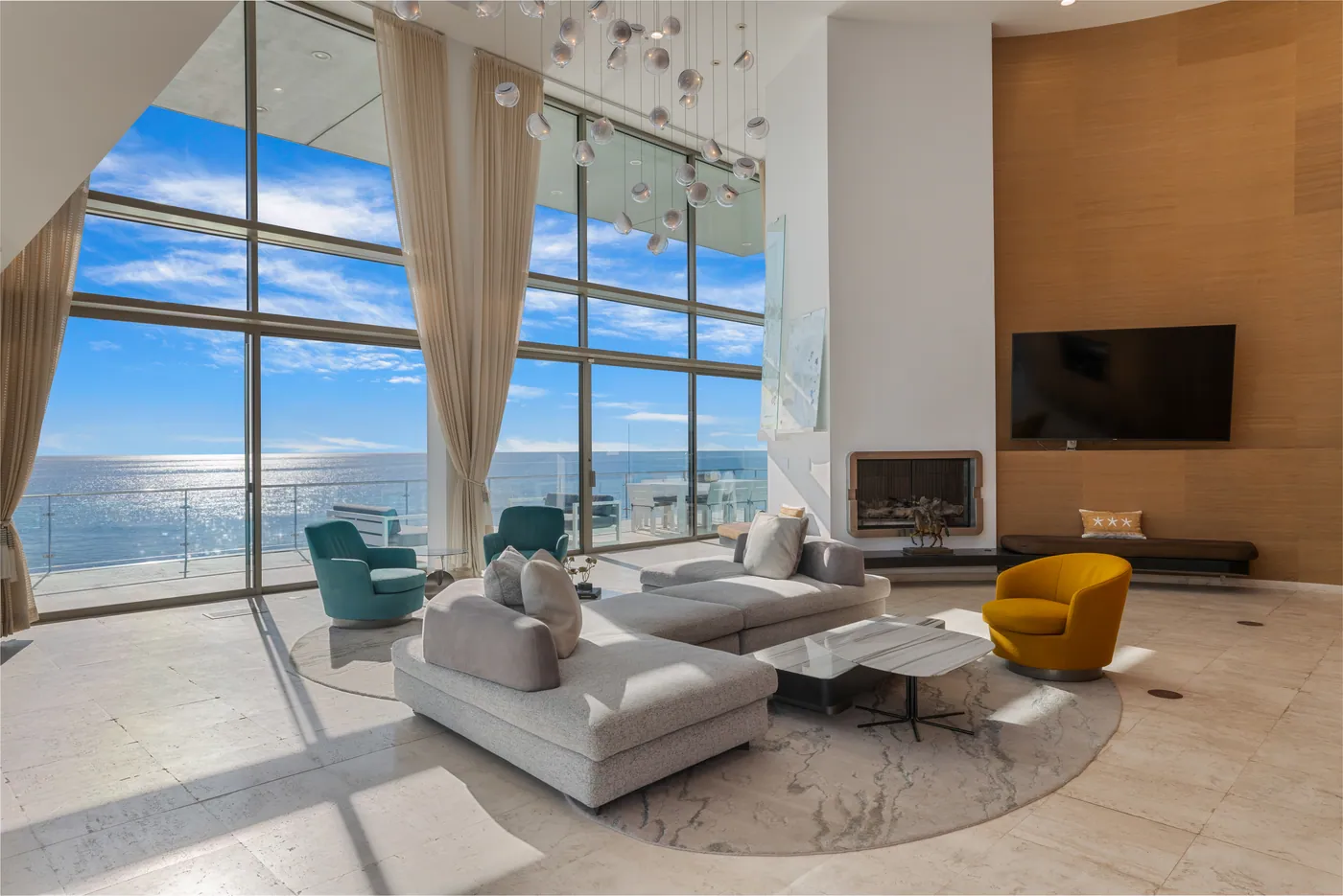 Double-height living room facing the ocean