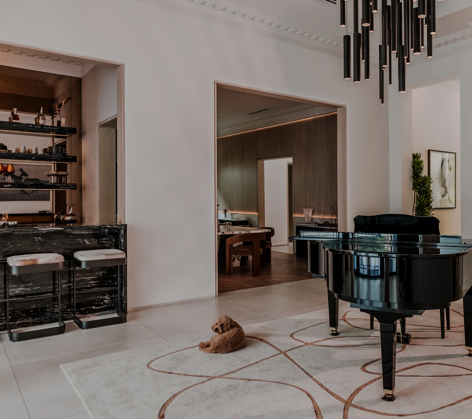 The foyer after the renovation: black stone bar, piano and the opening to the dining room