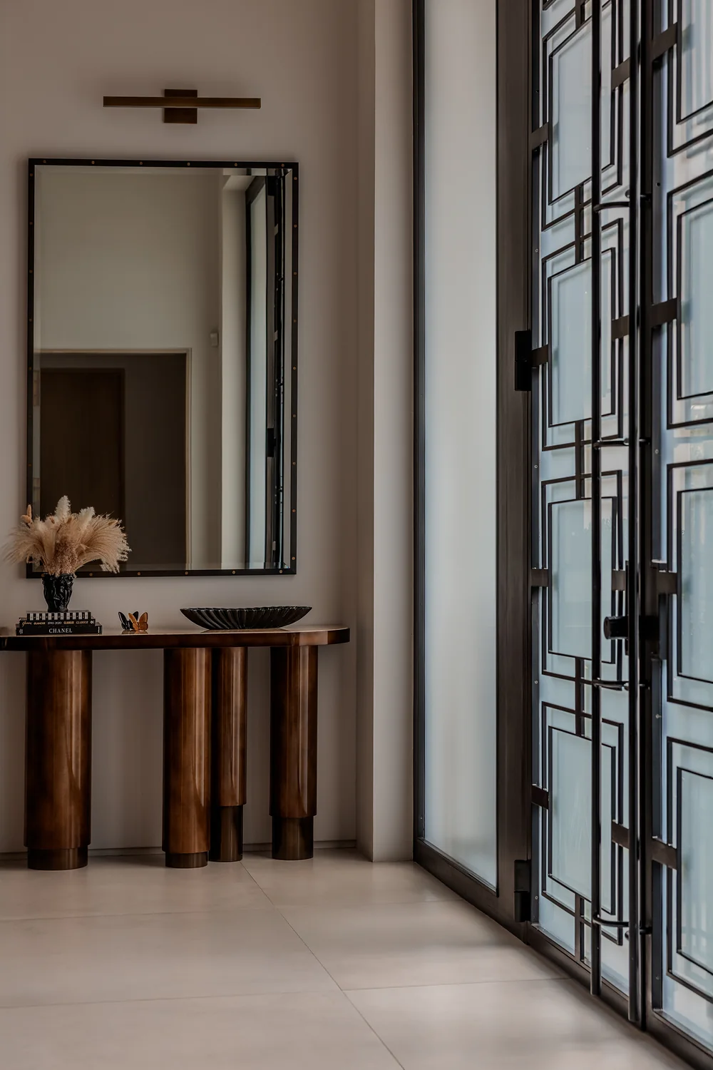 Entry console and mirror opposite the front doors