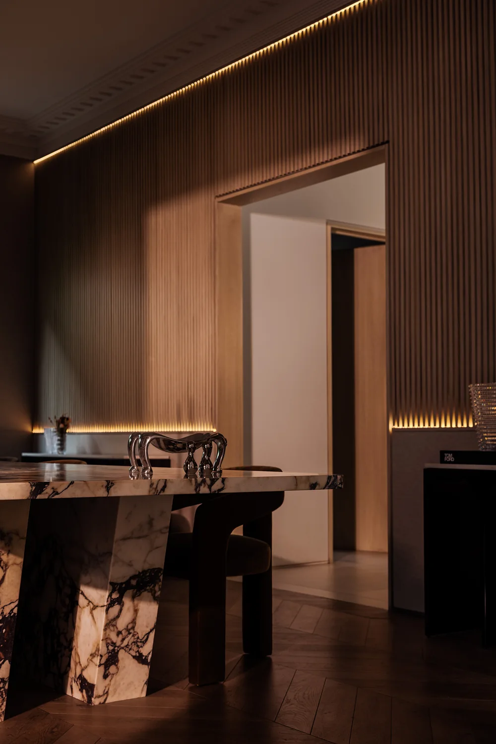 Dining room lined in oak slats with a stone table
