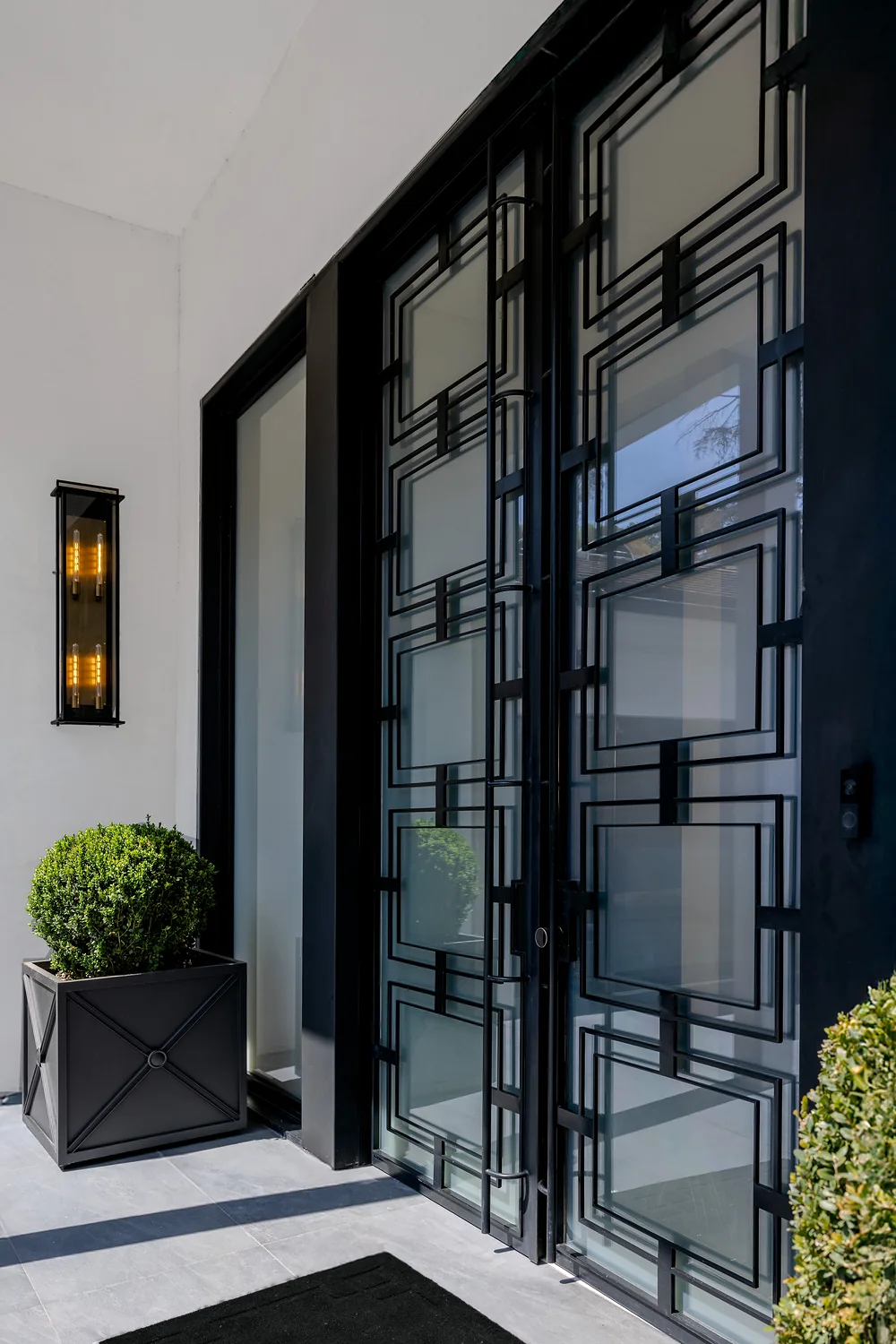 Steel-and-glass entry doors set in a deep black frame