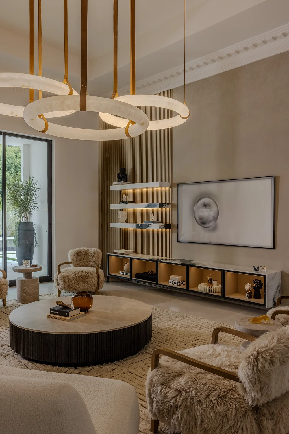 Living room with alabaster ring chandelier and low built-in console