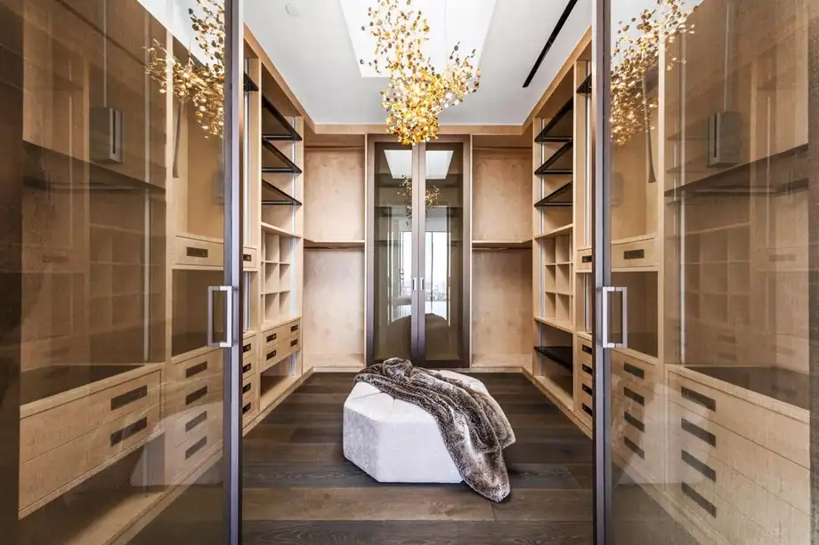 A dressing room with fluted timber joinery and integrated lighting