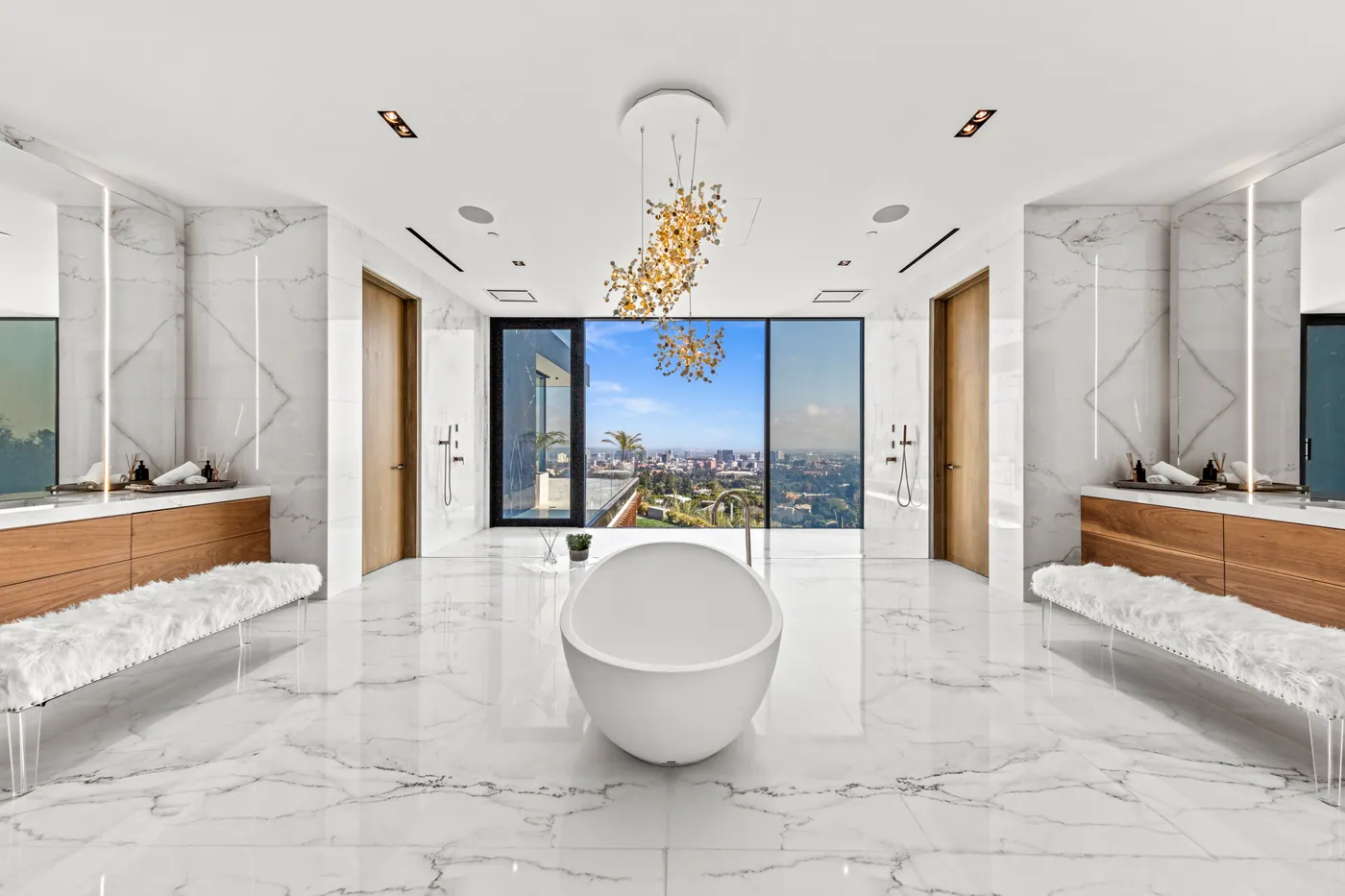 Primary bath with a freestanding tub and city view