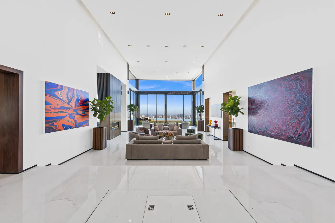 Living room framed by floor-to-ceiling glass