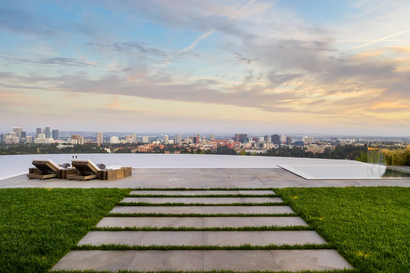 Pavers across the lawn to the pool deck at sunset