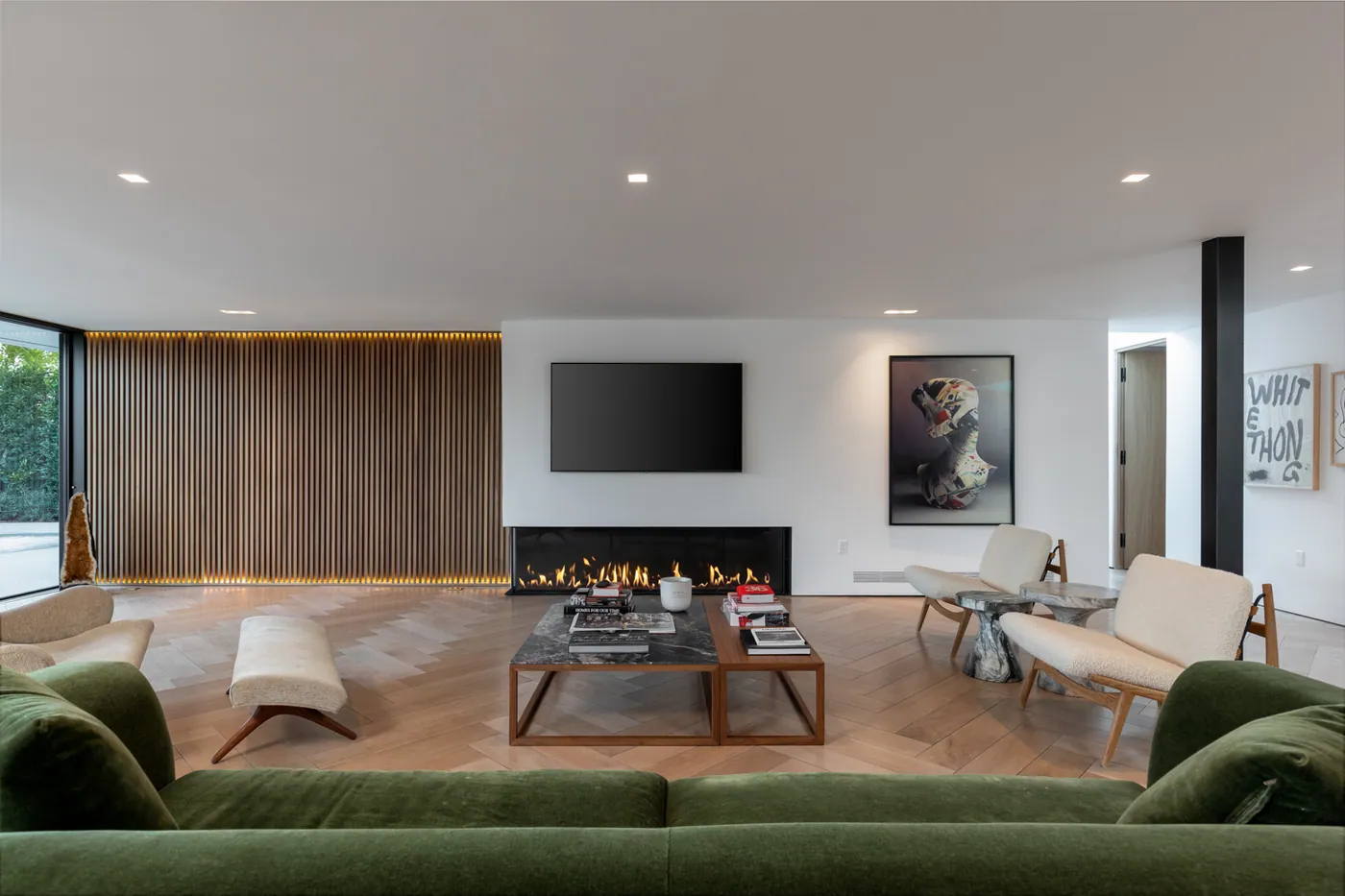 Living room with fireplace and green velvet sofa